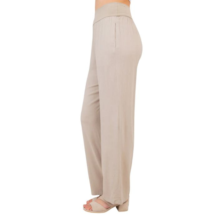 female model wearing sand brown landon pants side view on white background