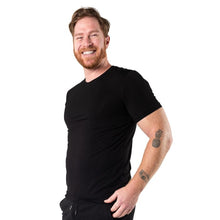 top of male model wearing black lawrence crew neck t-shirt side view on white background