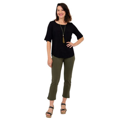 female model wearing black liza top and khaki green nadine cropped pants front view on white background