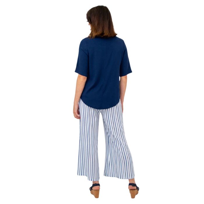 female model wearing indigo blue liza top and landon pants back view on white background