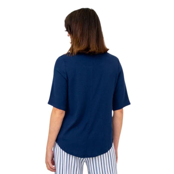 female model wearing indigo blue liza top back view on white background