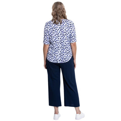 model wearing indigo rain liza top and indigo blue belle capri pants back view on white background