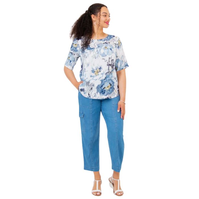 female model wearing muse print liza top and denim blue cropped pants front view on white background