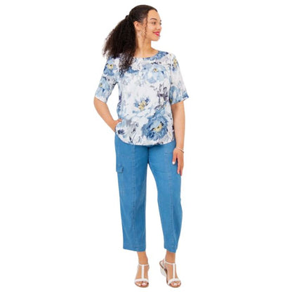 female model wearing muse print liza top and denim blue cropped pants front view on white background