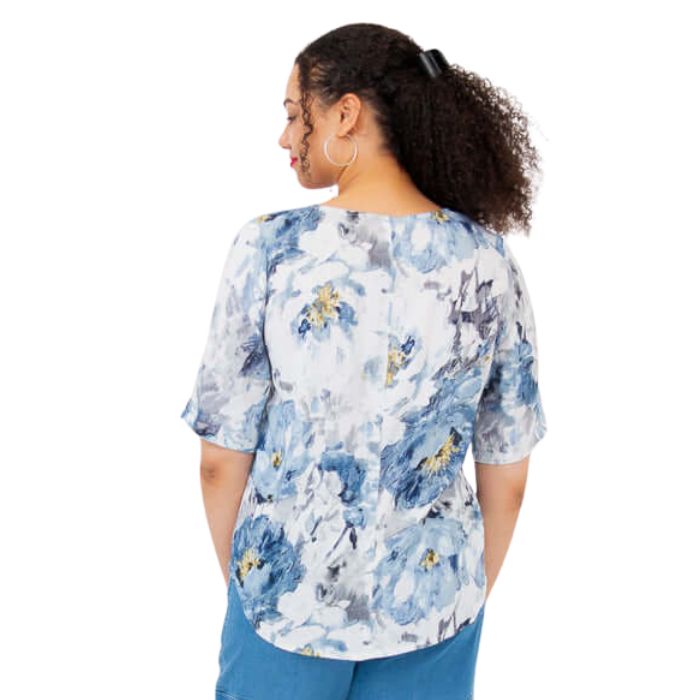 model wearing muse print liza top waist up back view on white background