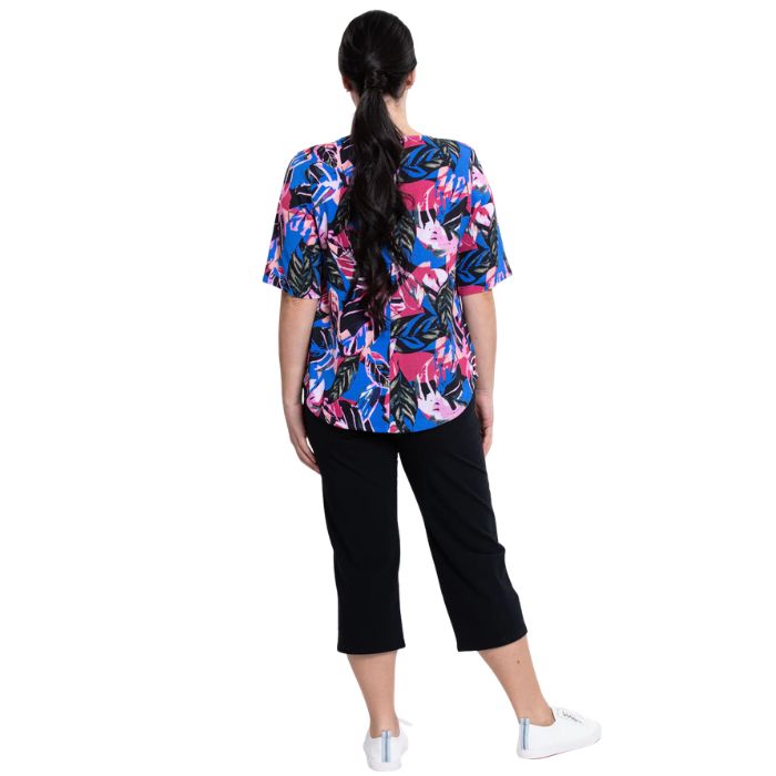 female model wearing pink bonita print liza top and black nadine cropped pants back view on white background
