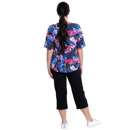 female model wearing pink bonita print liza top and black nadine cropped pants back view on white background