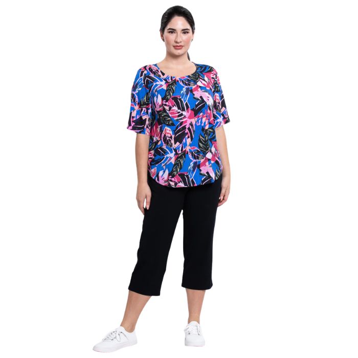 female model wearing pink bonita print liza top and black nadine cropped pants front view on white background