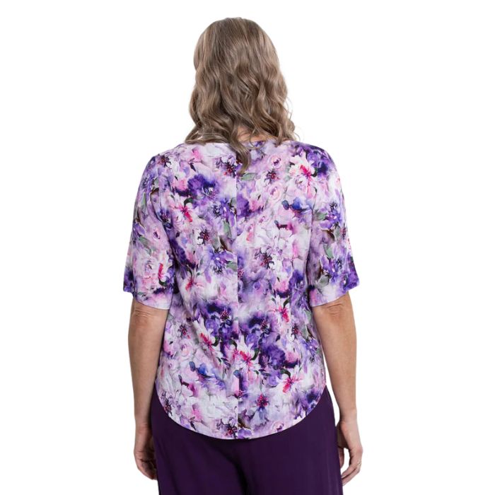 model wearing royale dynasty liza top back view on white background