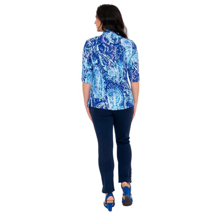 model wearing curious print lorine blouse and indigo blue nadia pants  back view on whitte background