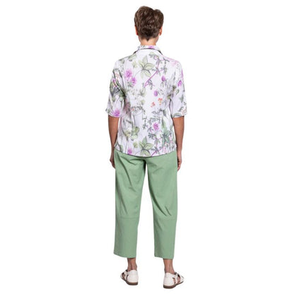 model wearing khaki clover print lorine blouse and sage green boardwalk capri pants back view on whitte background