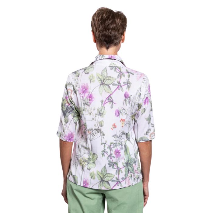 model wearing khaki clover print lorine blouse back view on whitte background