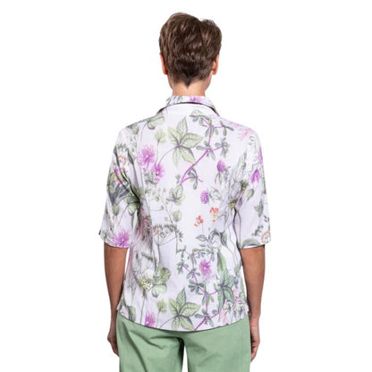 model wearing khaki clover print lorine blouse back view on whitte background