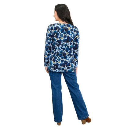 a woman wearing blue wind print margie top and denim blue jeans back view set on a studio white background