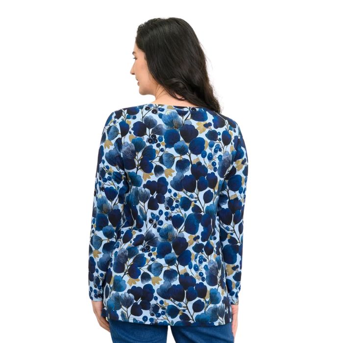 a woman wearing blue wind print margie top waist up back view set on a studio white background