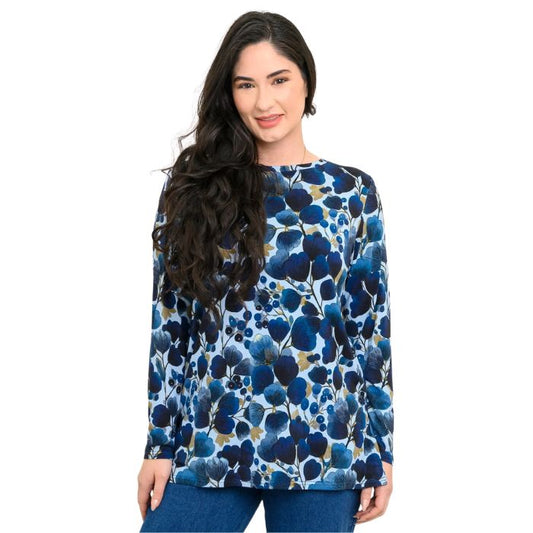 a woman wearing blue wind print margie top waist up front view set on a studio white background
