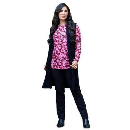 a woman wearing vermillion rose print margie top and black nadia pants front view set on a studio white background