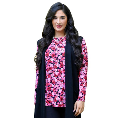 a woman wearing vermillion rose print margie top waist up front view set on a studio white background