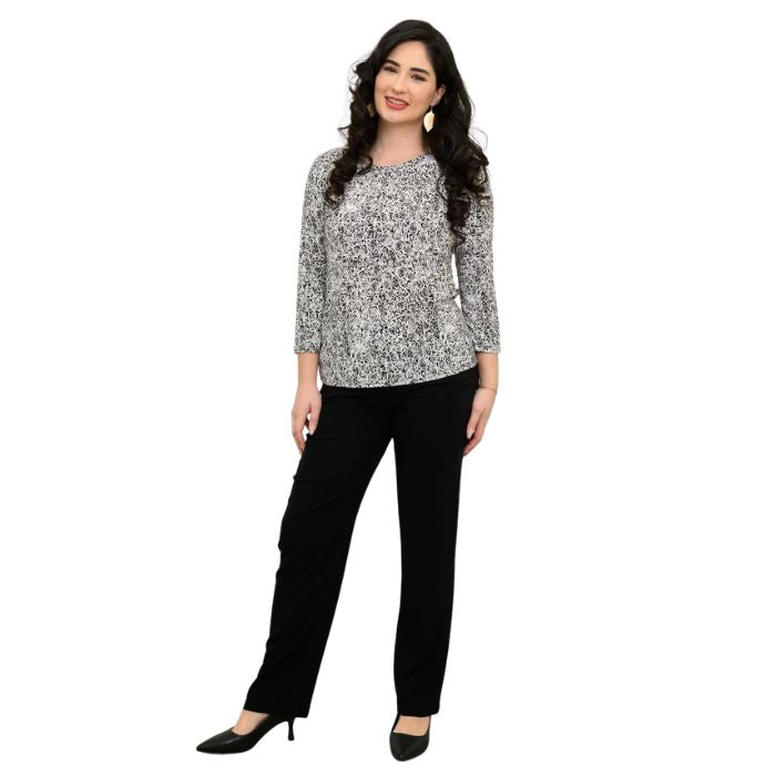 female model wearing rosette print margorie three quarter sleeve top and black nadia pants front view on white background