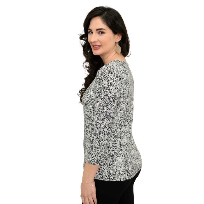 female model wearing rosette print margorie three quarter sleeve top side view on white background