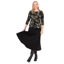female model wearing margorie khaki oak three quarter sleeve top print and gillian black long skirt front view on white background