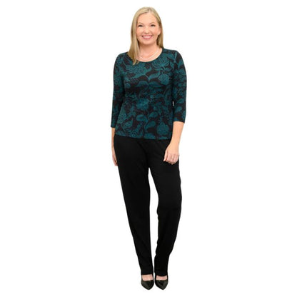 woman wearing margorie teal boscage print three quarter sleeve top and black nadia pants front view set on a white background 