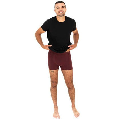 man wearing maroon red boxer briefs and black lawrence crew tee front view set on a white background