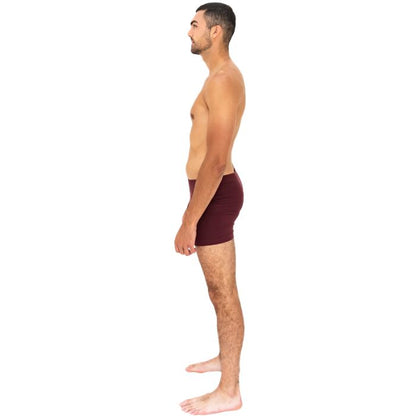 man wearing maroon red terrera boxer briefs side view set on a white background