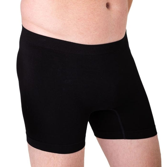 body of male model wearing black boxer briefs front view on white background
