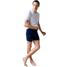male model wearing ink blue boxer briefs and white huron v-neck tee front view on white background