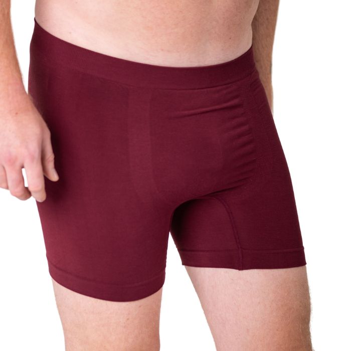 body of male model wearing maroon red boxer briefs front view on white background