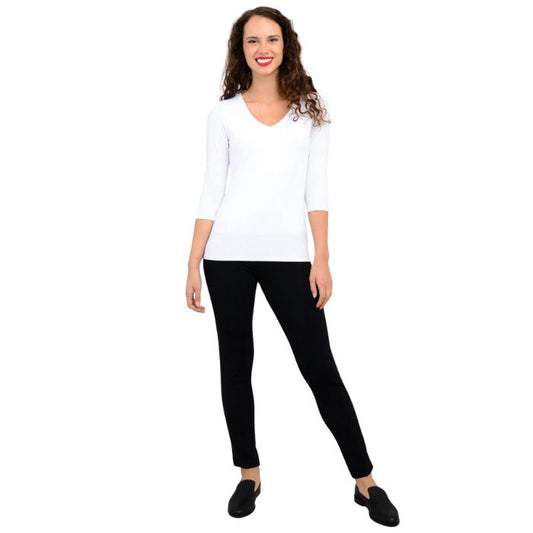female model wearing mia white three quarter sleeve top and nadia black pants front view on white background