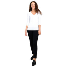 female model wearing mia white three quarter sleeve top and nadia black pants front view on white background