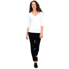 female model wearing mia white three quarter sleeve top and nadia black pants front view on white background