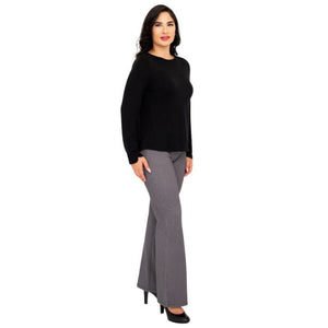 female model wearing mona black long sleeve top and daya pants side  view on white background