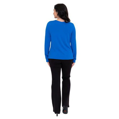 female model wearing mona cobalt blue long sleeve top and daya black pants back view on white background