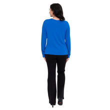 female model wearing mona cobalt blue long sleeve top and daya black pants back view on white background