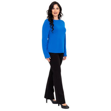 female model wearing mona cobalt blue long sleeve top and daya black pants front view on white background