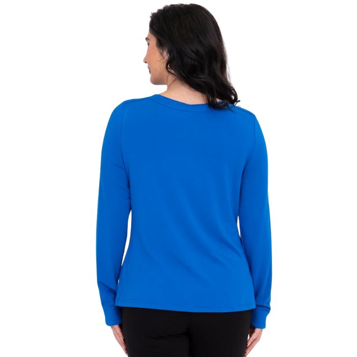 top of female model wearing mona cobalt blue long sleeve top back view on white background