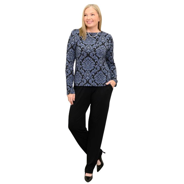 woman wearing indigo empire print mona top and black clair pants front view set on a white background
