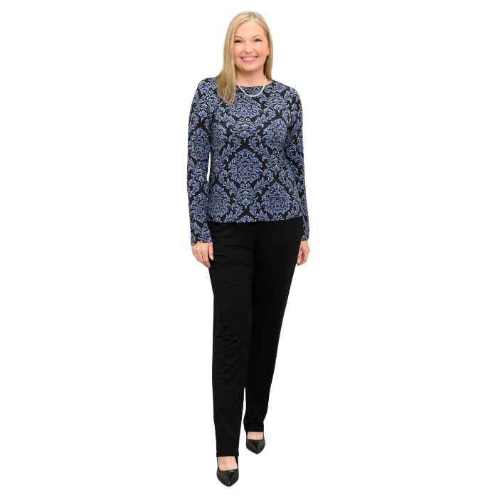 woman wearing indigo empire print mona top and black clair pants front view set on a white background