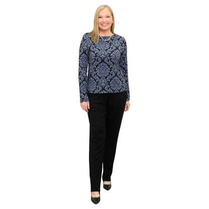 woman wearing indigo empire print mona top and black clair pants front view set on a white background