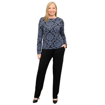 woman wearing indigo empire print mona top and black clair pants front view set on a white background