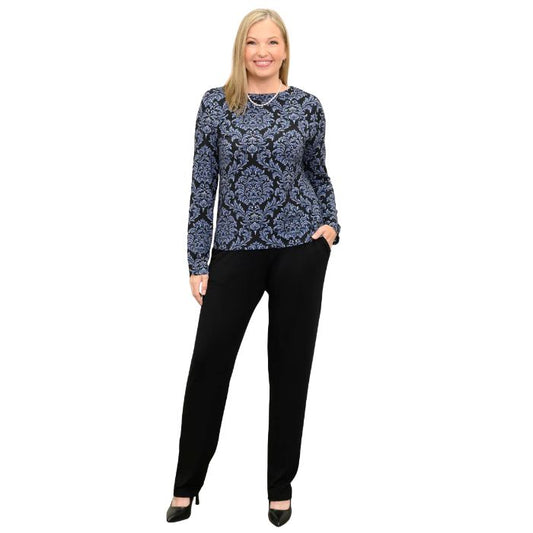 woman wearing indigo empire print mona top and black clair pants front view set on a white background