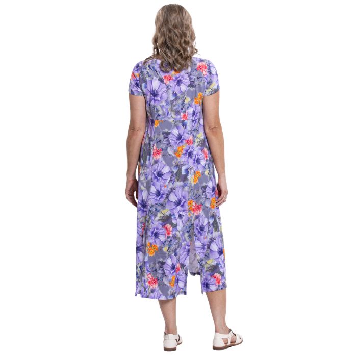 female model wearing violet bloom print morgan dress back view on white backgreond