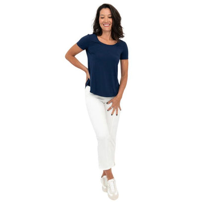 female model wearing white nadine cropped pants and indigo blue tessa tee front view on white background