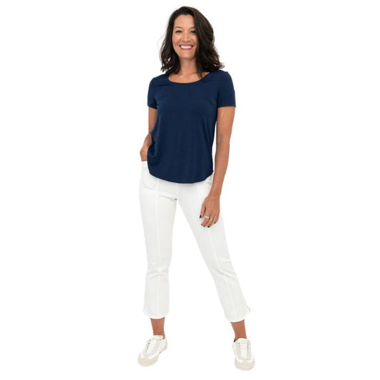 female model wearing white nadine cropped pants and indigo blue tessa tee front view on white background