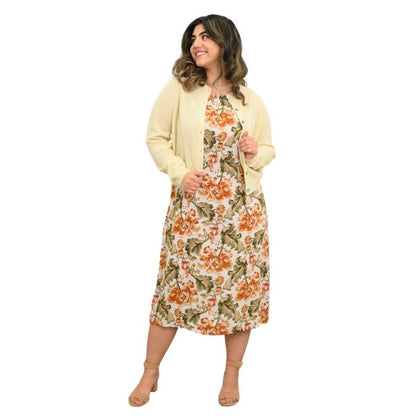 female model wearing khaki tapestry print patricia dress and marigold isabella sweater front view on white background