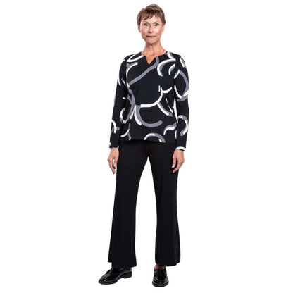 woman wearing black white focus print peggy top and black parker pants front view set on a white background