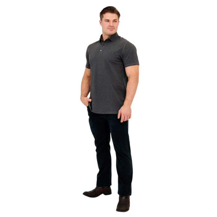 male model wearing graphite grey phil polo shirt and blue jeans front view on white background